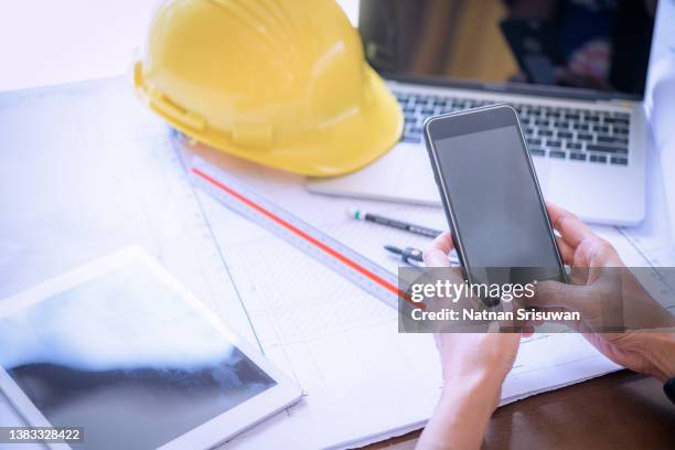 architectural plan, laptop, dividers ,pencil ,pen ,ruler, glasses and smartphone and blueprint on wooden table. architectural blueprints office desk background construction project ideas concept. - office desk top view stockfoto's en -beelden