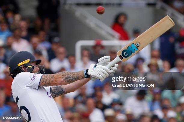 England's captain Ben Stokes hits a six off the bowling of Australia's Josh Hazlewood on day five of the second Ashes cricket Test match between...