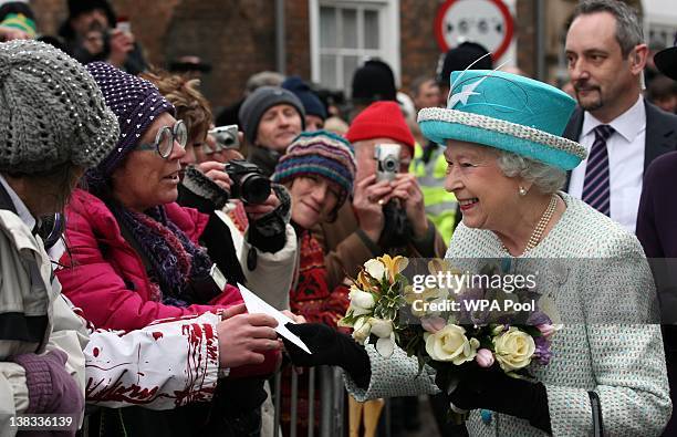 Queen Elizabeth II is greeted by wellwishers during a visit to Kings Lynn Town Hall on February 6, 2012 in Norfolk, England. Today is Accession Day,...