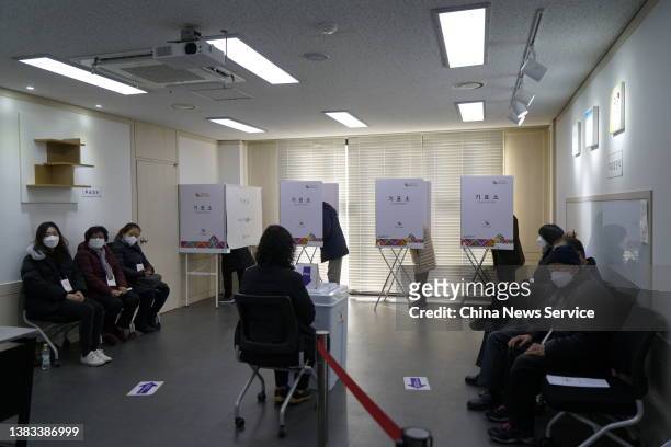 Voters mark their ballots for presidential election at a polling station on March 9, 2022 in Seoul, South Korea.