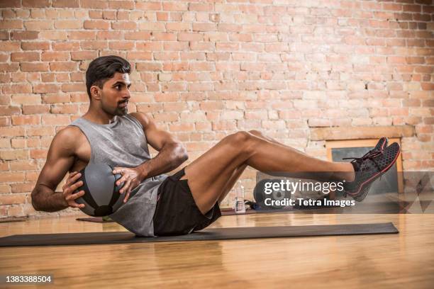 man exercising with medicine ball in gym - medicine ball stock pictures, royalty-free photos & images