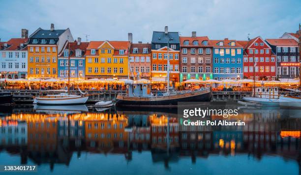 copenhagen iconic view. famous old nyhavn port in the center of copenhagen, denmark at dusk. - nyhavn stock pictures, royalty-free photos & images