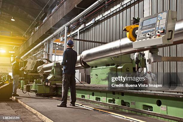 workers in a steel factory - industria foto e immagini stock