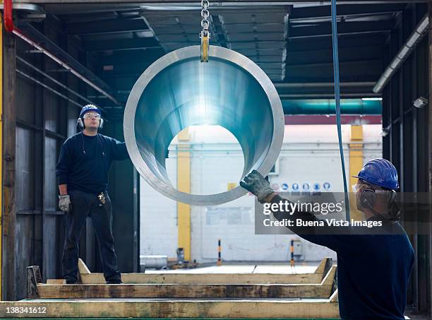 workers in a steel factory - manufacturing occupation stock-fotos und bilder