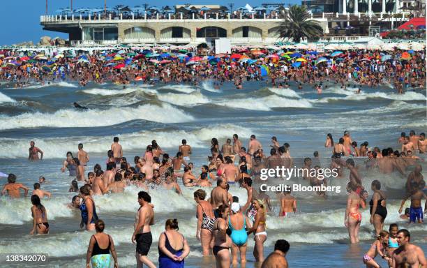 People in swim in the ocean at Las Toscas beach in Mar del Plata, Argentina, on Saturday, Jan. 28, 2012. Brazil and Argentina plan to discuss...