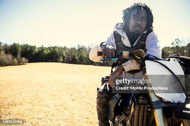 portrait of dirt biker with his motorcycle - protective sportswear ストックフォトと画像