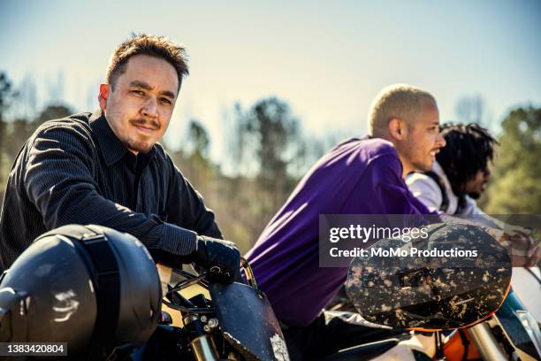 portrait of a group of dirt bikers - motorcycle group stock pictures, royalty-free photos & images