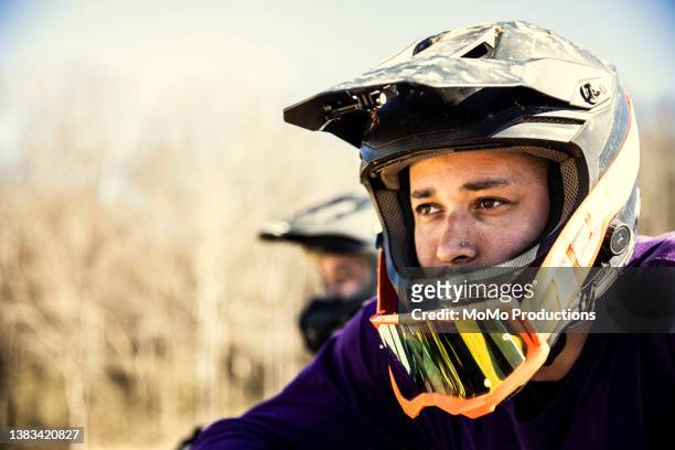 closeup of dirt biker wearing helmet - stuntman stock-fotos und bilder