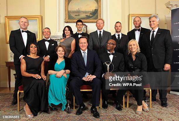 Prime Minister David Cameron poses for a photograph with sports personalities Sean Fitzpatrick, Gary Player, Nadia Comaneci, Novak Djokovic, Boris...