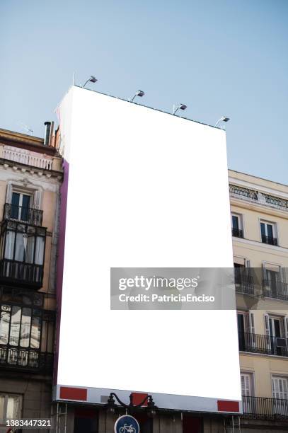 blank poster on a building facade - blank billboard stockfoto's en -beelden