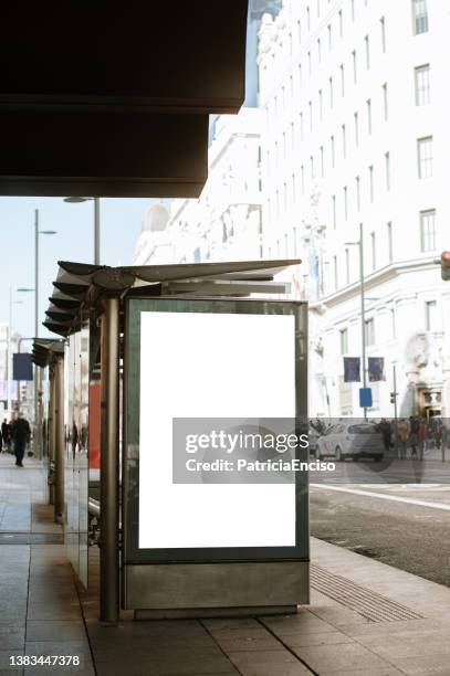 bus stop with blank poster - bus stop poster stock pictures, royalty-free photos & images