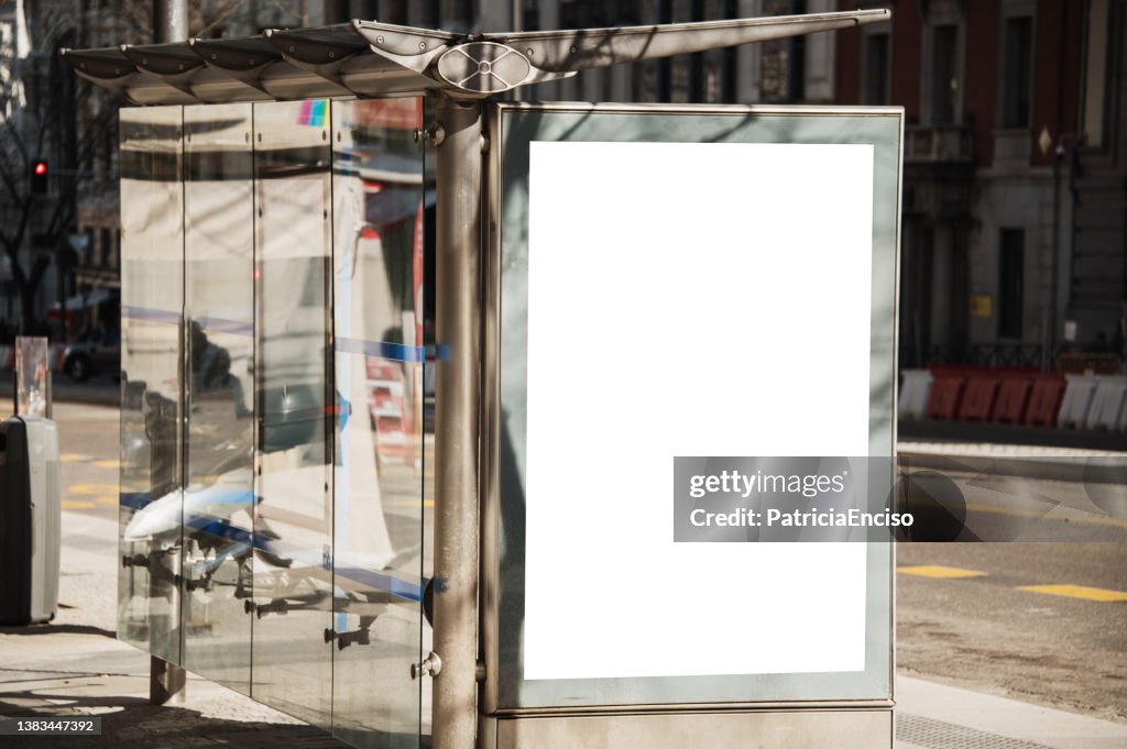 Bus stop with blank poster