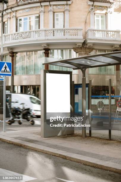 bus stop with blank poster - bus stop stock pictures, royalty-free photos & images