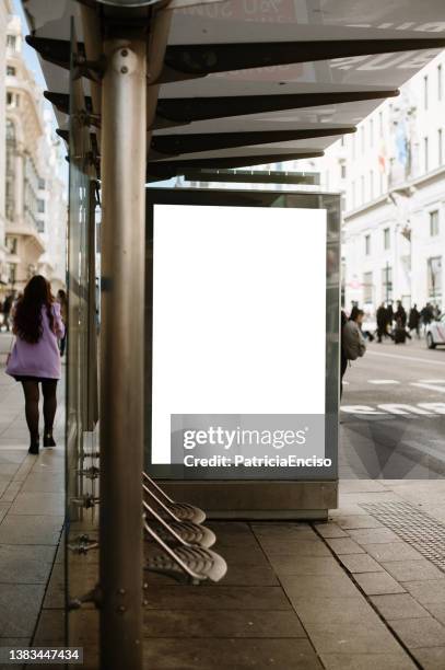 bus stop with blank poster - bus stop poster stock pictures, royalty-free photos & images