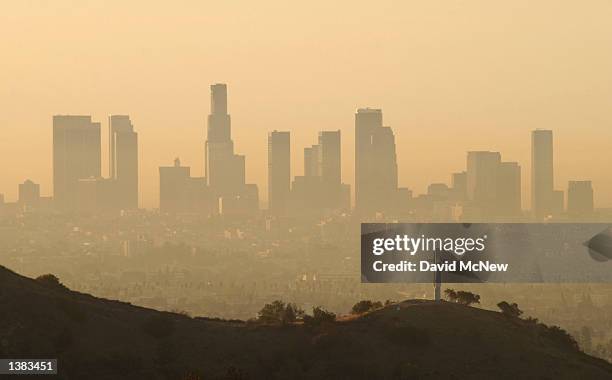 Downtown highrise buildings are shown cloaked in dirty air shortly after sunrise September 11, 2002 in Los Angeles, California. Although air quality...