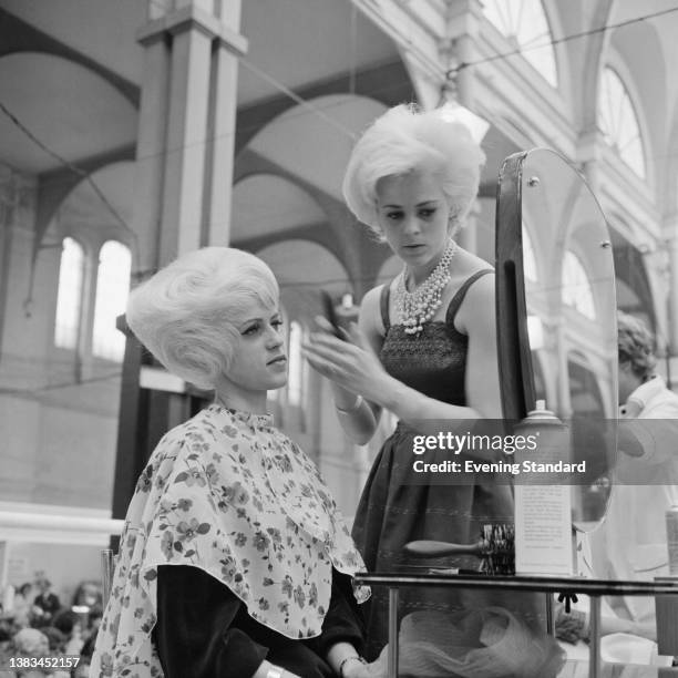 Stylist at work at the Hairdressing Exhibition at Alexandra Palace in London, UK, 6th May 1963.