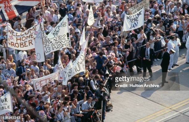 Crowds on the quayside at Portsmouth waiting for the arrival of the British light aircraft carrier HMS Invincible from the Falkland Islands after the...