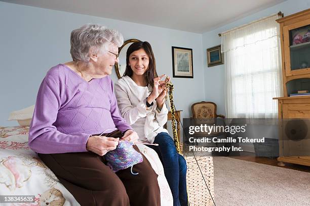 grandmother and granddaughter knitting together - old granny knitting stock pictures, royalty-free photos & images