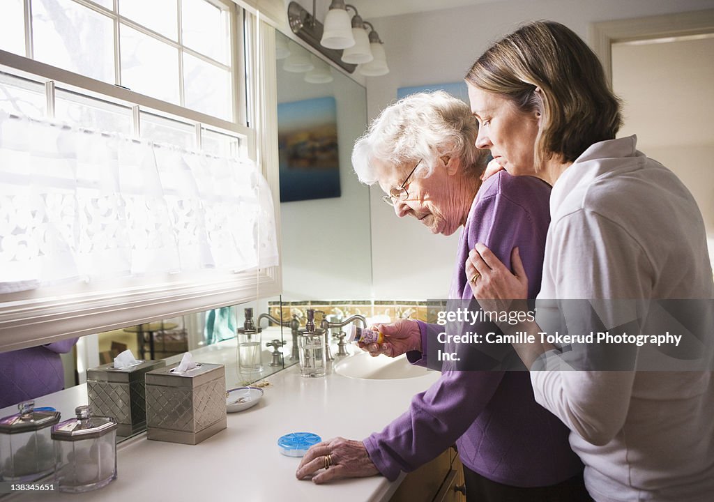 Daughter and Elderly mother checking medicine