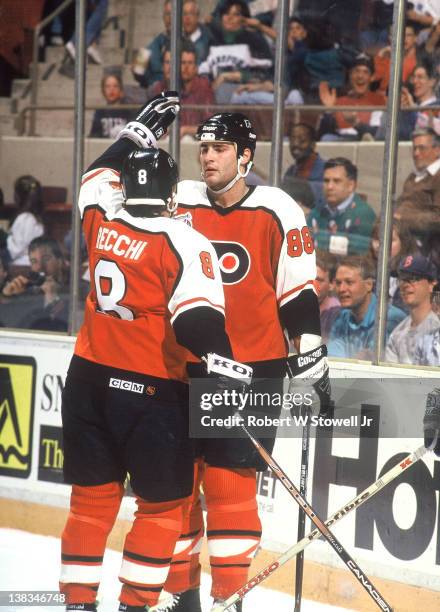 Canadian ice hockey player Eric Lindross and teammate Mark Recchi, both of the Philadelphia Flyers. Celebrate a goal by Lindross during a game...