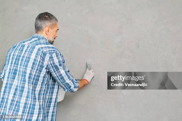 mature man working on concrete wall texture - concrete architecture stock pictures, royalty-free photos & images