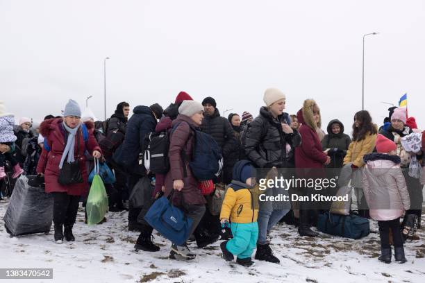 Refugees fleeing conflict make their way to the Krakovets border crossing with Poland on March 09, 2022 in Krakovets, Ukraine. More than a million...