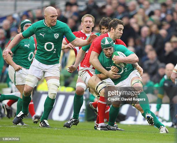 Sean O'Brien of Ireland is tackled by Ryan Jones during the RBS Six Nations match between Ireland and Wales on February 5, 2012 at the Aviva Stadium...