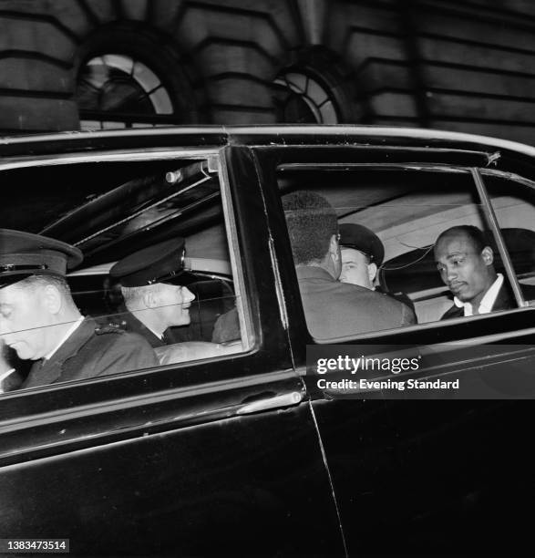 British jazz singer Aloysius 'Lucky' Gordon and Johnny Edgecombe , in a car with a police escort during the trial of osteopath Stephen Ward, 10th...