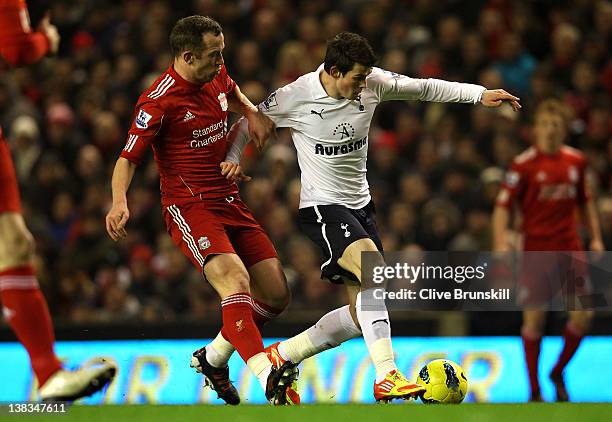 Charlie Adam of Liverpool challenges Gareth Bale of Tottenham Hotspur during the Barclays Premier League match between Liverpool and Tottenham...