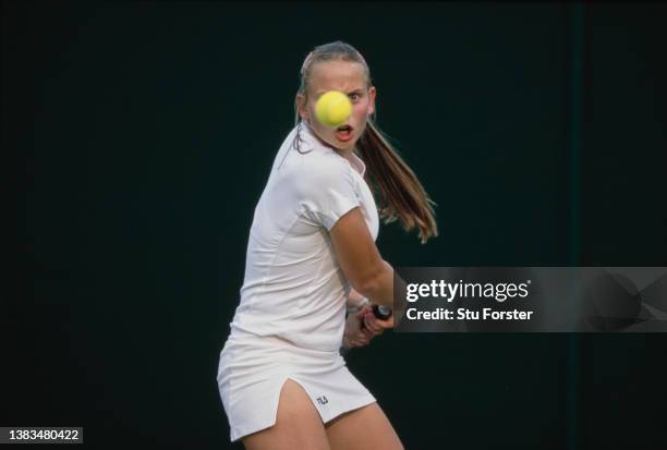 Jelena Dokic from Yugoslavia keeps her eye on the tennis ball playing a double handed backhand return against Greta Arn of Germany during their...