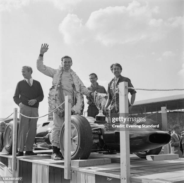 Scottish racing driver Jim Clark wins the 1963 British Grand Prix at Silverstone, in a Lotus Climax Lotus 25, UK, 20th July 1963. On the left is...