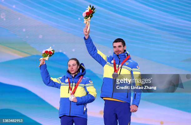 Silver medalist Oksana Shyshkova of Team Ukraine celebrates on the podium with her guide during the medal ceremony for the Women's Sprint Free...