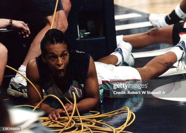 American basketball player Teresa Weatherspoonn of the New York Liberty expresses shock as she lies tangled in cables after falling out of bounds...