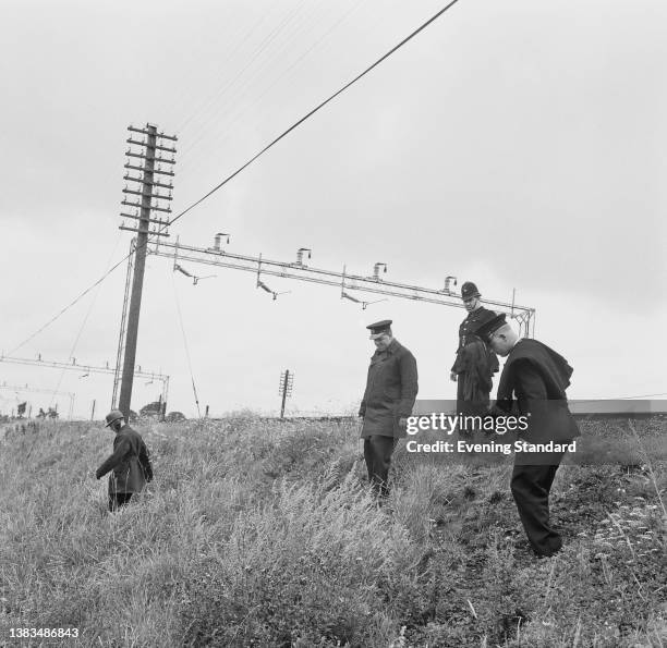 Police officers searching for clues by the railway track at Sears Crossing in Ledburn, between Leighton Buzzard and Cheddington, after the Great...