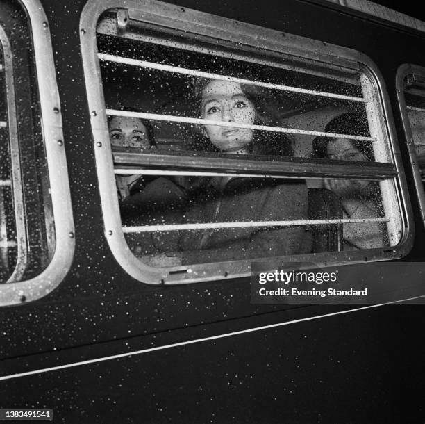 English model Christine Keeler and her friend Paula Hamilton-Marshall being driven in a police van from Marylebone Lane police station to Marlborough...