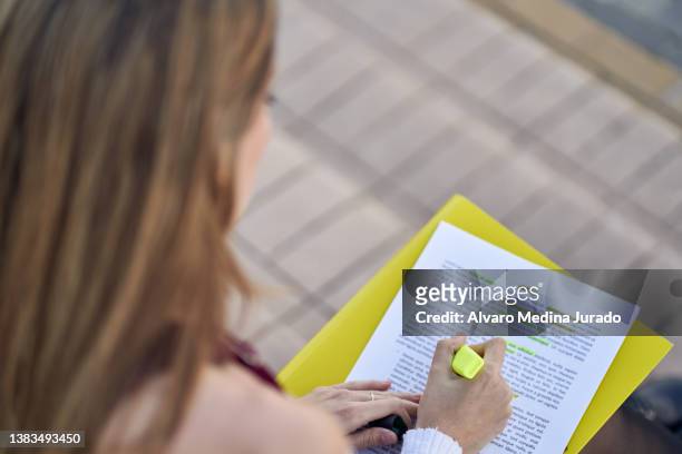 woman highlighting text in document while studying - workbook stock pictures, royalty-free photos & images