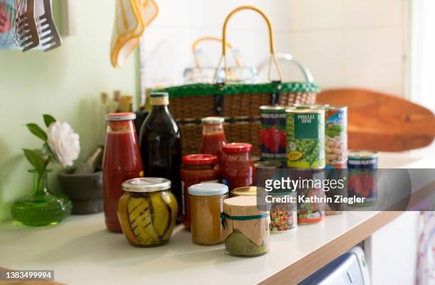 unpacked groceries on kitchen counter, canned and preserved foods - canned goods stock pictures, royalty-free photos & images