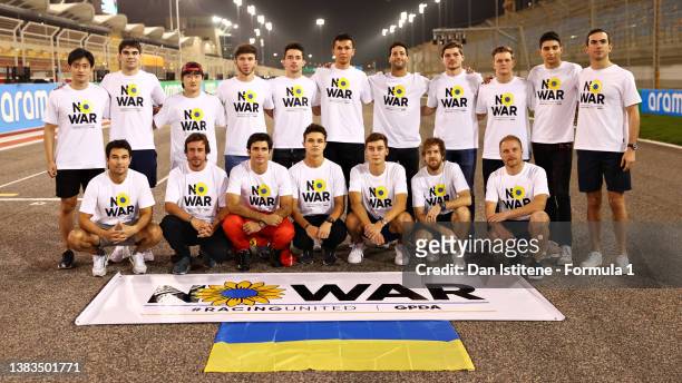 Drivers pose with a banner promoting peace and sympathy with Ukraine prior to F1 Testing at Bahrain International Circuit on March 09, 2022 in...