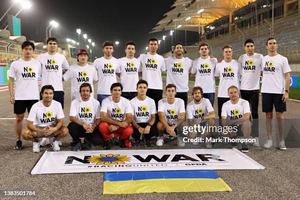 Drivers pose with a banner promoting peace and sympathy with Ukraine prior to F1 Testing at Bahrain International Circuit on March 09, 2022 in...