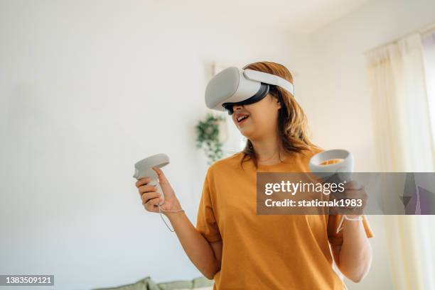 young asian woman exercising with a vr headset at home - self control stock pictures, royalty-free photos & images