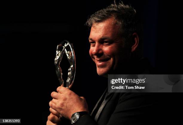 Golfer Darren Clarke with his Laureus World Comeback of the Year trophy poses in the press room at the 2012 Laureus World Sports Awards at Queen...