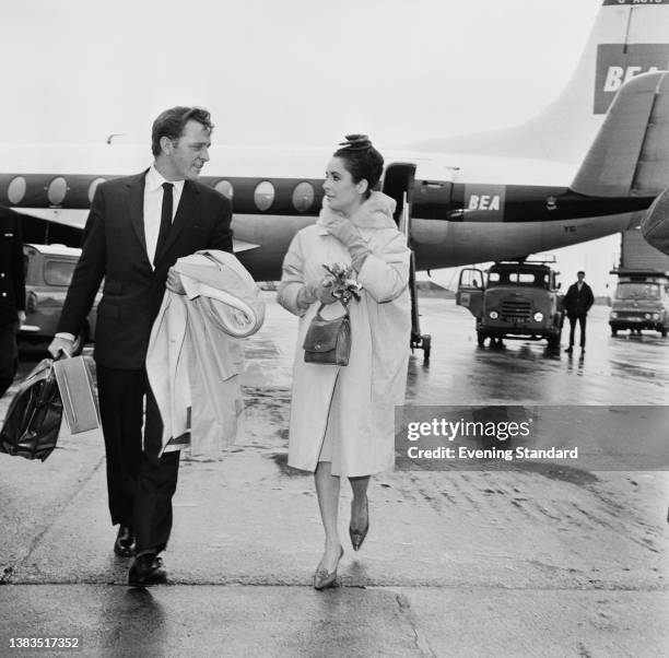 Actors Richard Burton and Elizabeth Taylor arrive at London Airport after a flight from Paris, France, 18th March 1963. They have just attended the...