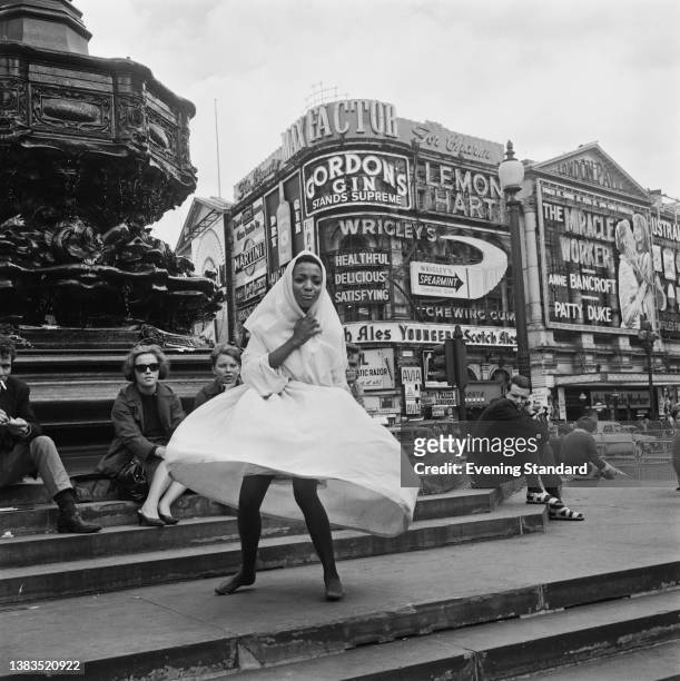 Dancer and actress Cristyne Lawson, a member of the cast of 'Black Nativity' poses at Piccadilly Circus in London, UK, 9th August 1962. The show, by...