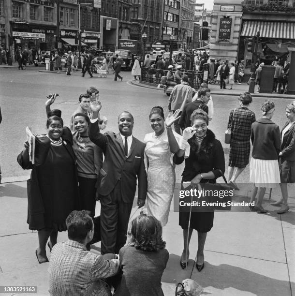 The cast of 'Black Nativity' pose at Piccadilly Circus in London, UK, 9th August 1962. The show, by Langston Hughes, is a retelling of the Christmas...