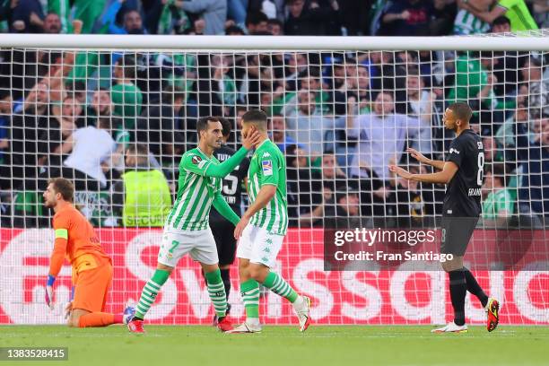 Nabil Fekir of Real Betis celebrates with teammate Juanmi after scoring their team's first goal during the UEFA Europa League Round of 16 Leg One...