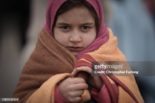 Refugee children fleeing Ukraine are given blankets by Slovakian rescue workers to keep warm at the Velke Slemence border crossing on March 09, 2022...