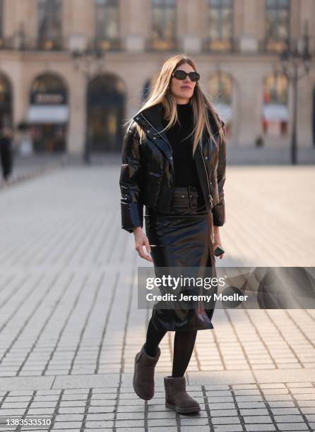 Veronika Heilbrunner seen wearing a brown sunglasses from Celine, silver earrings, a shiny down cropped puffer jacket, black turtleneck sweater, a...