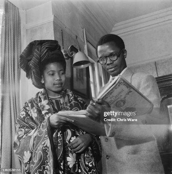 Prince Felix Osayande Akenzua, youngest son of Akenzua II, the Oba of Benin reading a book on art with Olufemi Jibowu, the daughter of Nigerian...