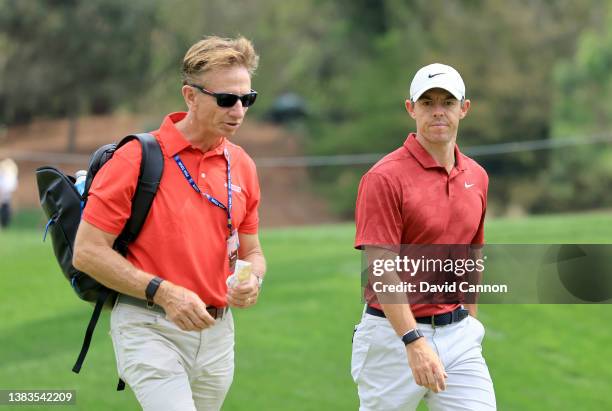 Rory McIlroy of Northern Ireland walks with Brad Faxon of the United States during a practice round prior to THE PLAYERS Championship at TPC Sawgrass...