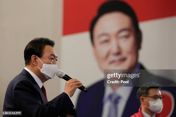 South Korean President-elect Yoon Suk-yeol of the main opposition People Power Party celebrates with party members and lawmakers at the National...